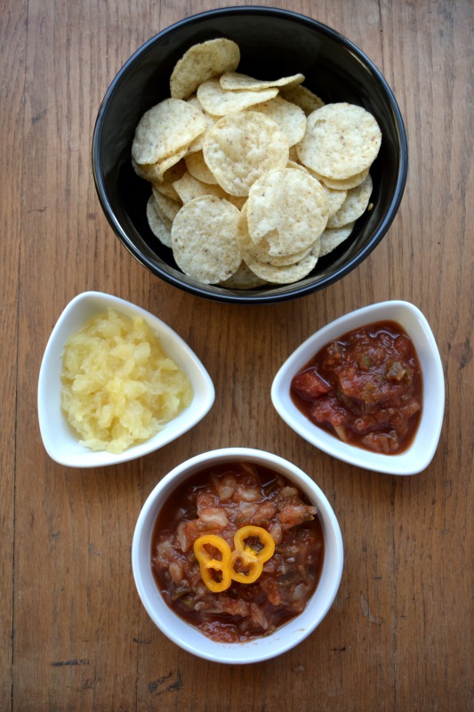 Fruity Spicy Pineapple Salsa with nachos in bowls.