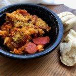 Black bowl of meat lovers pasta with bread on side from www.ApronFreeCooking.com