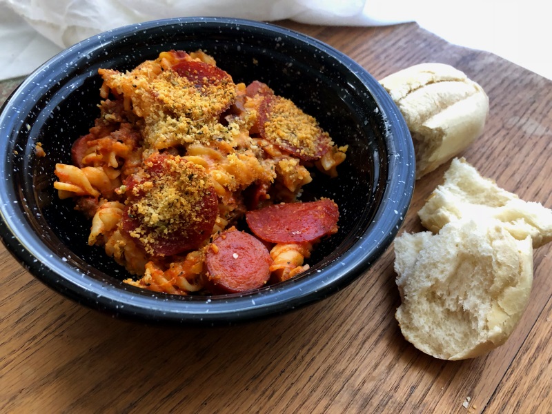 Black bowl of meat lovers pasta with bread on side from www.ApronFreeCooking.com 