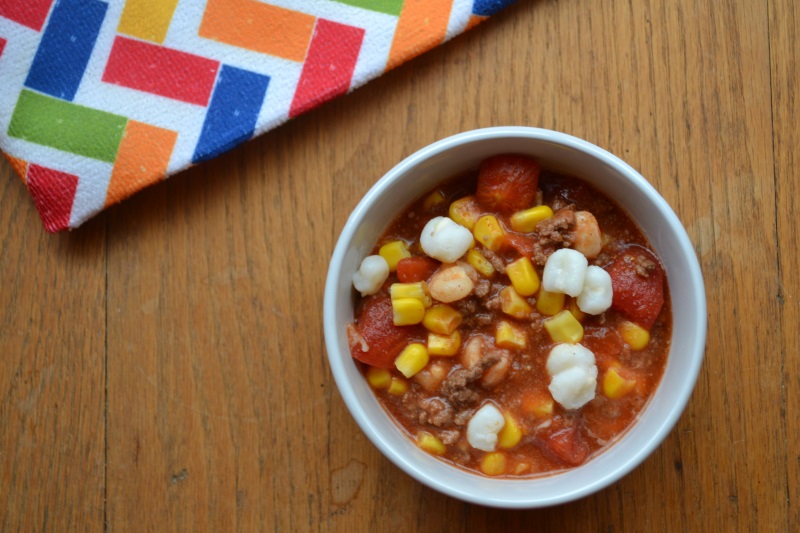 No Bean Chili in white bowl with mutli colored table cloth. Easy to make chili from www.ApronFreeCooking.com