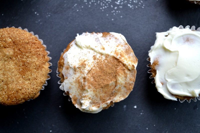 Fruit Cocktail Cake muffins topped with cream cheese icing and sprinkled with cinnamon from www.ApronFreeCooking.com