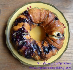 Blueberry Coffee Ring round cake on a yellow and green plate.