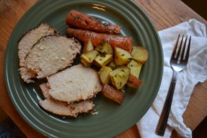 Slow Cooked Coffee Rubbed Pork Roast with roast carrots and red potatoes on a green plate from www.ApronFreeCooking.com