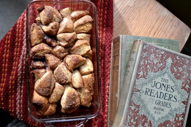 Pumpkin Spice Monkey Bread in a bread baking pan sitting on a desk next to old fashioned reader books from www.ApronFreeCooking.com 