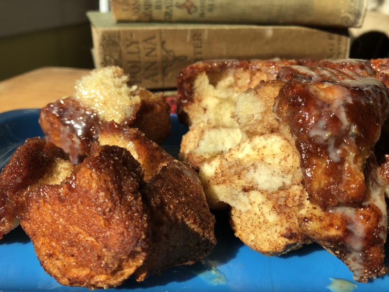 Close up of Pumpkin Spice Monkey Bread showing the spice covered bread bits with icing melting down the side from www.ApronFreeCooking.com 