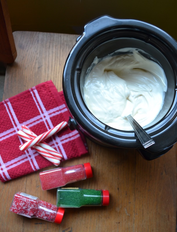 Christmas Brownies with white chocolate melting in crock pot and sprinkles