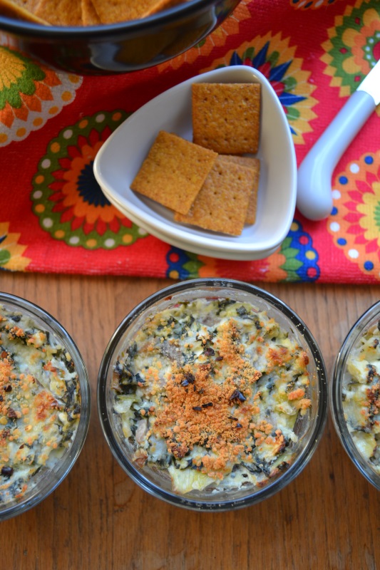 Spinach Artichoke Individual Appetizers on table with wheat chips.