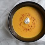 Savory Sweet Potato Soup in black bowl on white tablecloth. www.ArponFreeCooking.com