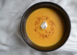 Savory Sweet Potato Soup in black bowl on white tablecloth. www.ArponFreeCooking.com