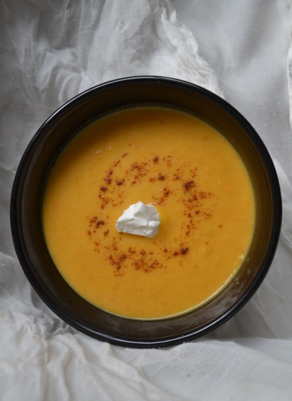 Savory Sweet Potato Soup in black bowl on white tablecloth. www.ArponFreeCooking.com