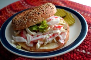 Easy Crab Salad Sandwich recipe served on a bagel from www.ApronFreeCooking.com