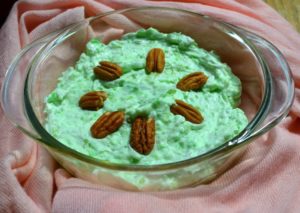 Vintage recipe for Watergate Salad in glass casserole on pink tablecloth from www.ApronFreeCooking.com