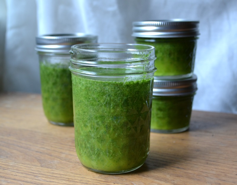 Garden fresh basil oil stored in mason jars from www.ApronFreeCooking.com