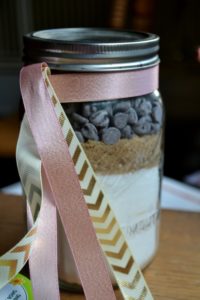 Jar of dry ingredients for Mason Jar Chocolate Chips Mania cookies from www.ApronFreeCooking.com