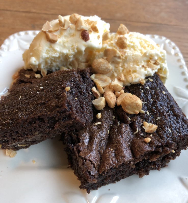 Mason Jar Brownies served with vanilla ice cream and chopped peanuts on white plate from www.ApronFreeCooking.com