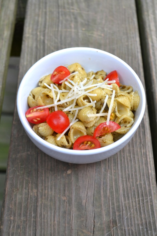 Basil pesto pasta with shell macaroni and tomatoes in white bowl from www.ApronFreeCooking.com
