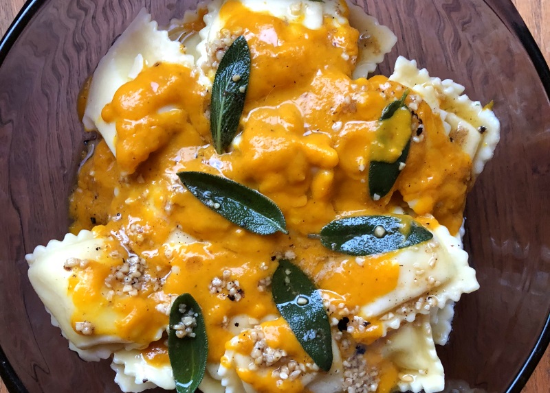 Pumpkin sauce with sage leaves in brown butter over cheese ravioli from www.ApronFreeCooking.com