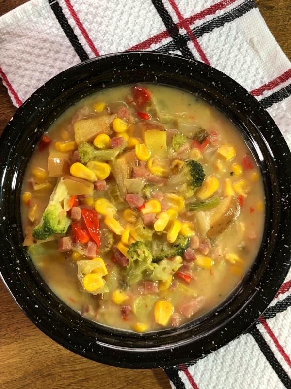 Overhead view of Vintage Farmhouse Chowder in a black bowl on white, red and blue cloth. from www.ApronFreeCooking.com