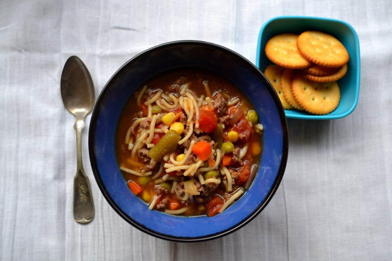 Hamburger Vegetable Soup in blue bowl on white background from www.ApronFreeCooking.com