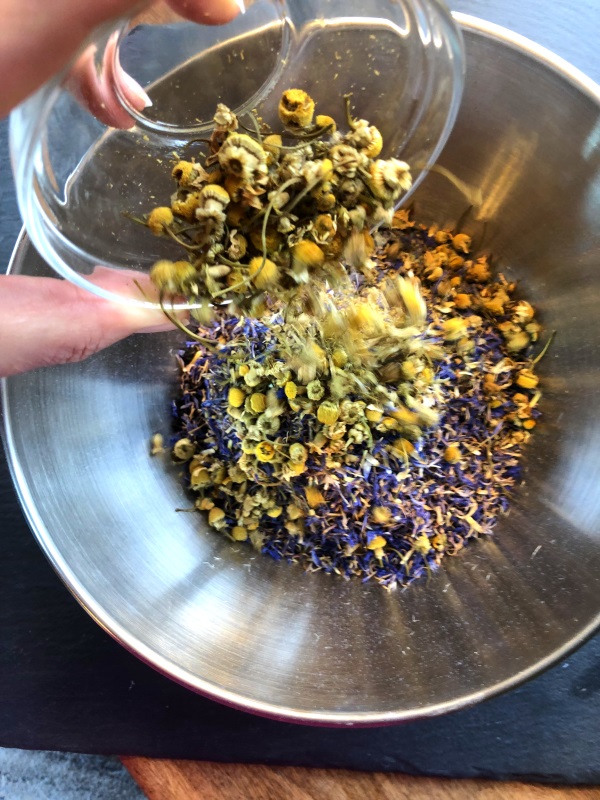 Yellow chamomile flowers added to loose leaf tea from www.ApronFreeCooking.com