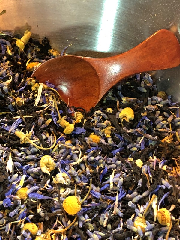 Close up of Blue Moon tea loose leaf blend with wooden measuring spoon in corner from www.ApronFreeCooking.com