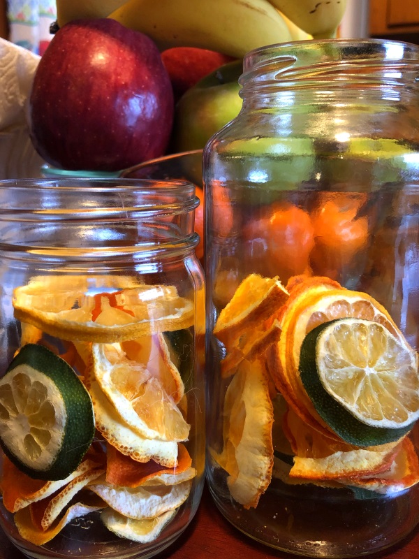 Two glass jars with slices of dehydrated citrus, lemons, oranges and lime from www.ApronFreeCooking.com