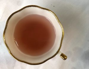 Lavender lemon tea, pretty pink liquid in white tea cup