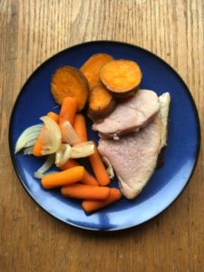 Crockpot ham supper with sweet potatoes, carrots and onions on a blue plate from www.ApronFreeCooking.com