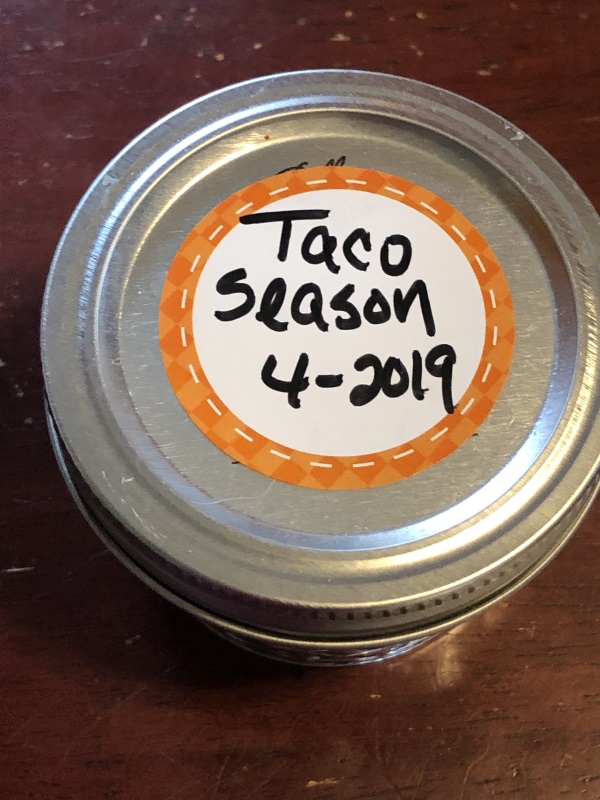 Small Mason jar with label on top that reads Taco Season 4-2019 from www.ApronFreeCooking.com