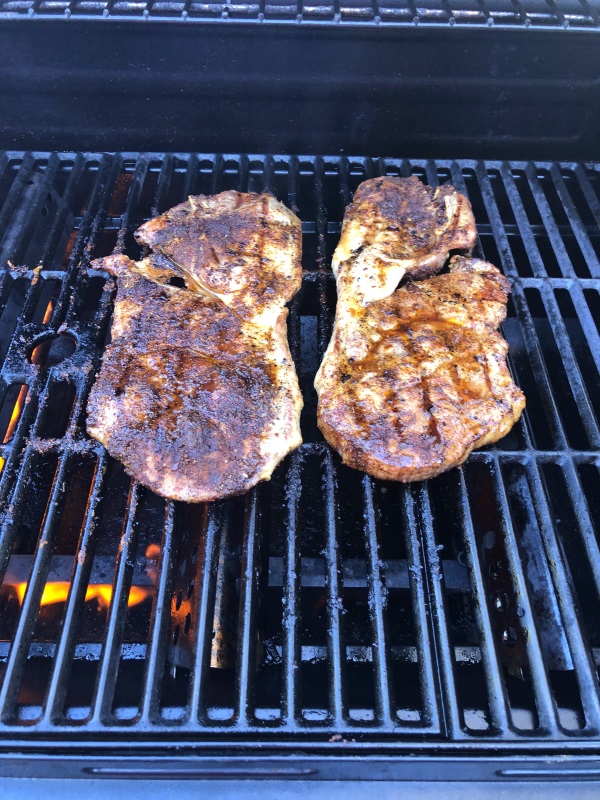 Two Taco Seasoned Grilled Steaks on the grill from www.ApronFreeCooking.com