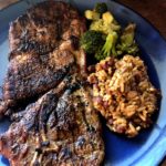 Taco Seasoned Grilled Steaks served with broccoli and beans & rice on blue plate from www.ApronFreeCooking.com