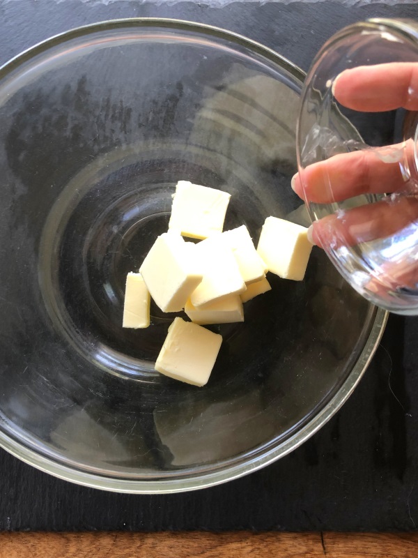 Butter pieces in glass mixing bowl