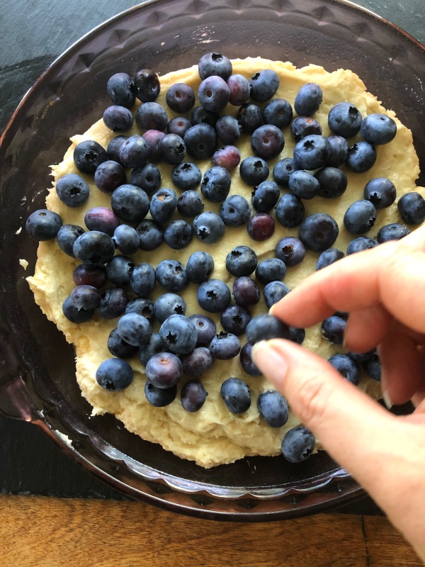 Step 12: add Berries on top of batter in baking pan to make blueberry buckle