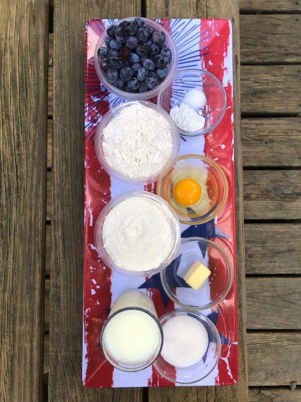 Blueberry Cornbread Muffin Ingredients viewed from above lined up on flag printed tray