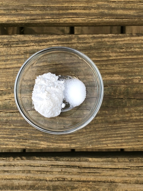 Blueberry Cornbread Muffin Ingredients Baking Powder Salt seen from above in small glass bowl on wooden background.