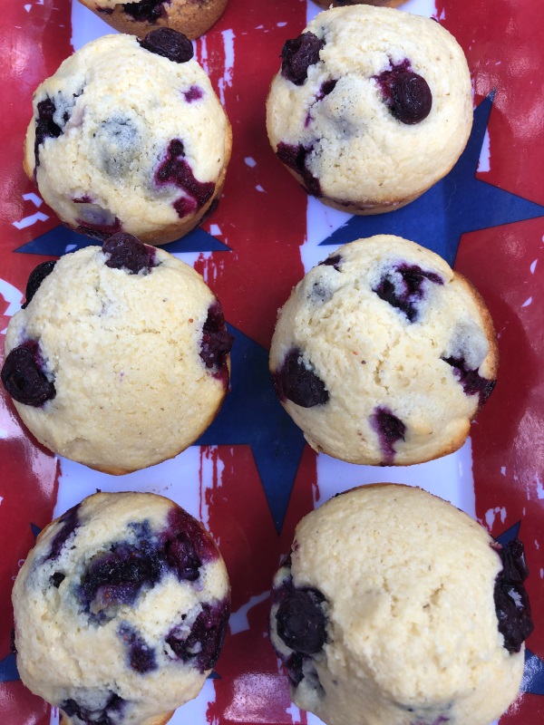 Overhead view of Rows of Blueberry Cornbread Muffins on a flag printed tray