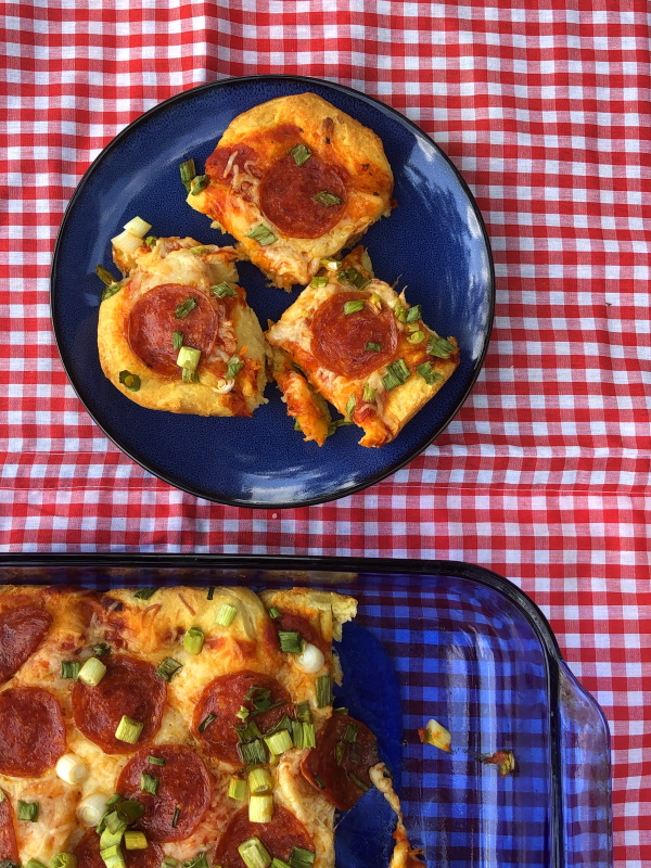 overhead view of pan with easy biscuit pizza in it and a plate with three slices on it