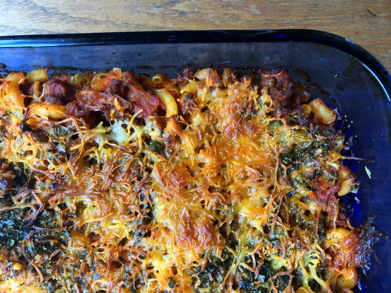 Blue casserole pan full of Johnny Marzetti, a macaroni, tomato sauce and ground beef dish