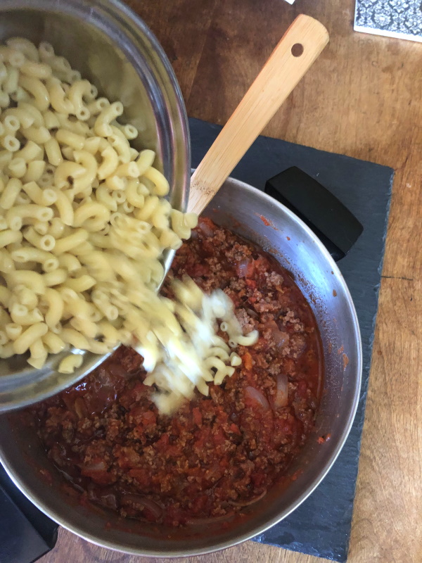 Johnny Marzetti Step  Stir cooked macaroni into pasta sauce with ground beef