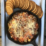 baked pizza dip in cast iron skillet