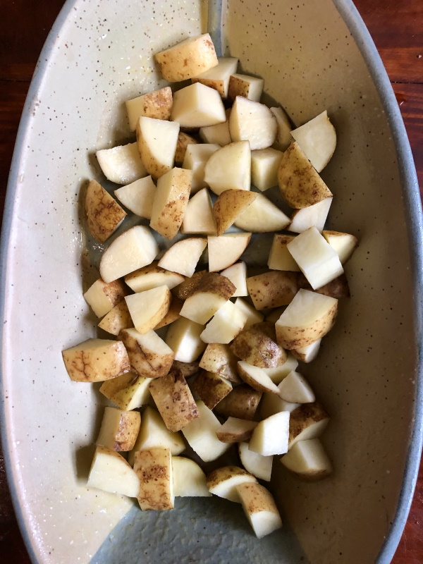 diced potatoes in casserole dish for herb roasted potatoes